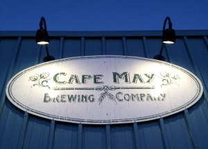The brightly lit sign of the brewery.